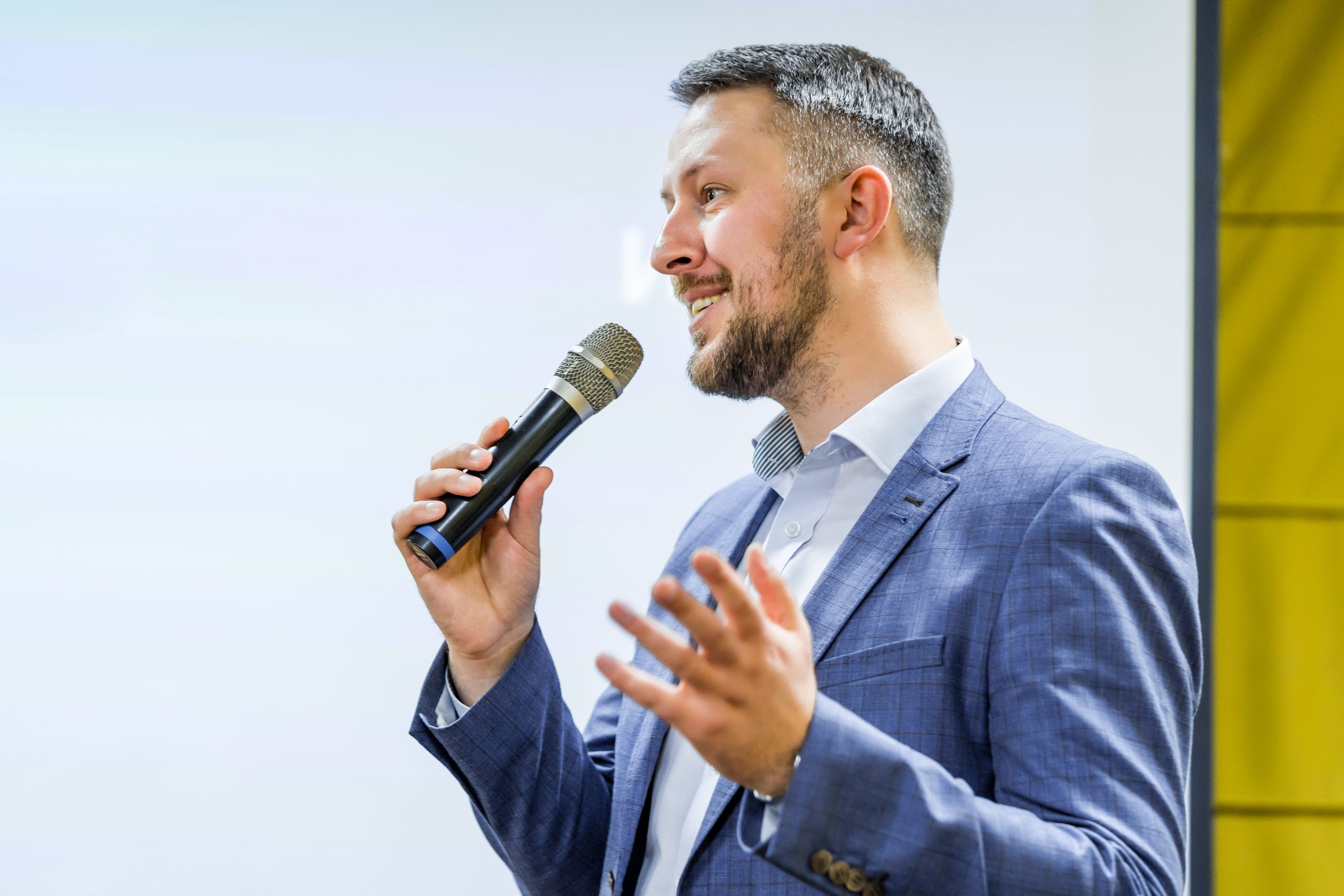 man with a microphone giving presentation